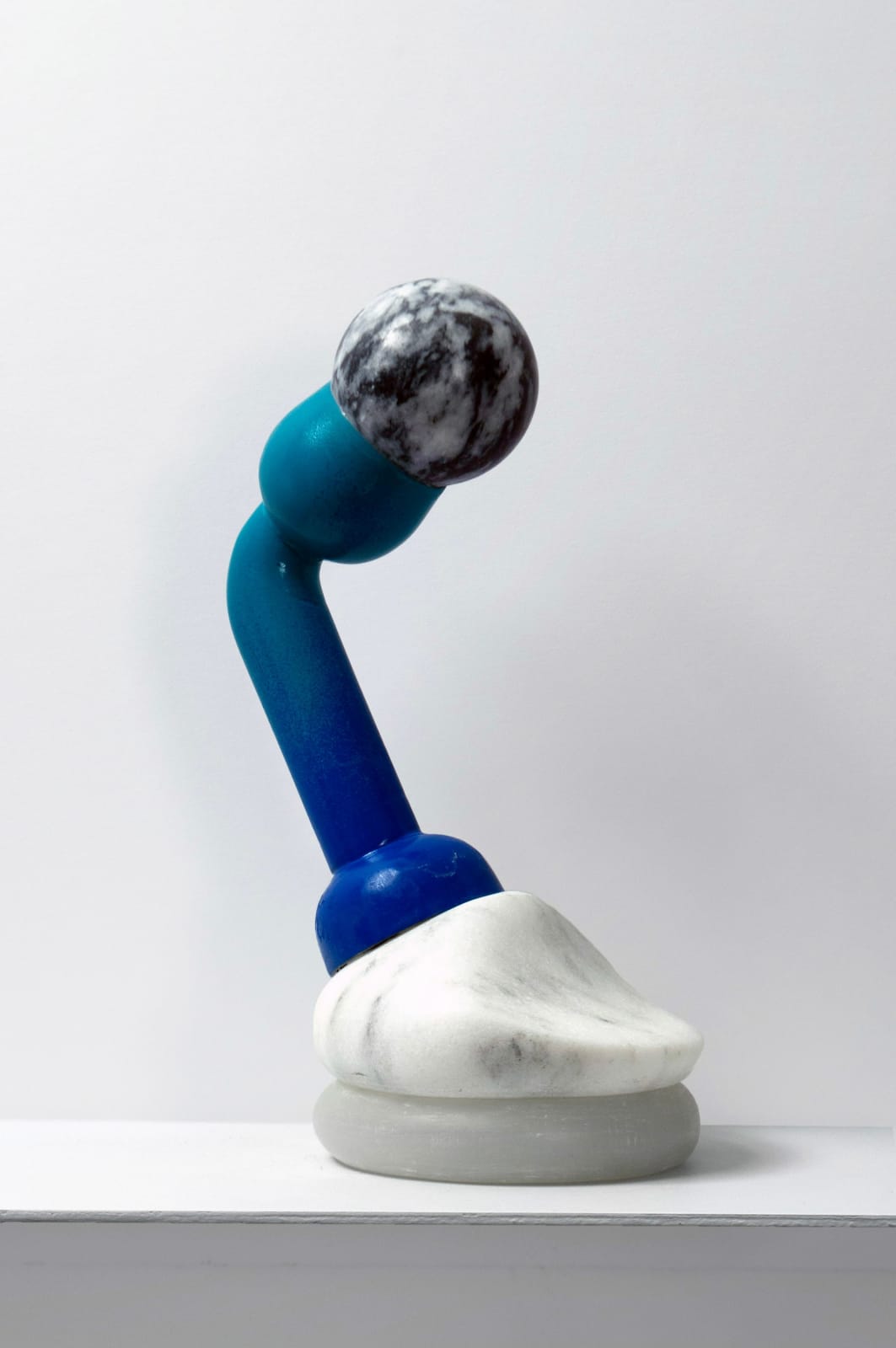 Contemporary minimalist sculpture made of stone and metal that resembles an ambiguous artifact