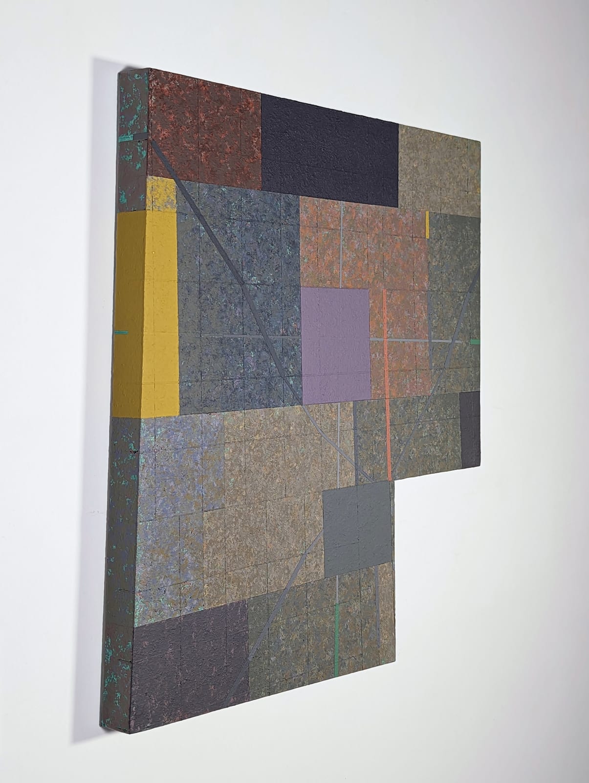 Six-sided shaped acrylic painting divided into rectangular parcels of muted yellows, greens, blues, and purples with a faint grid overlaid