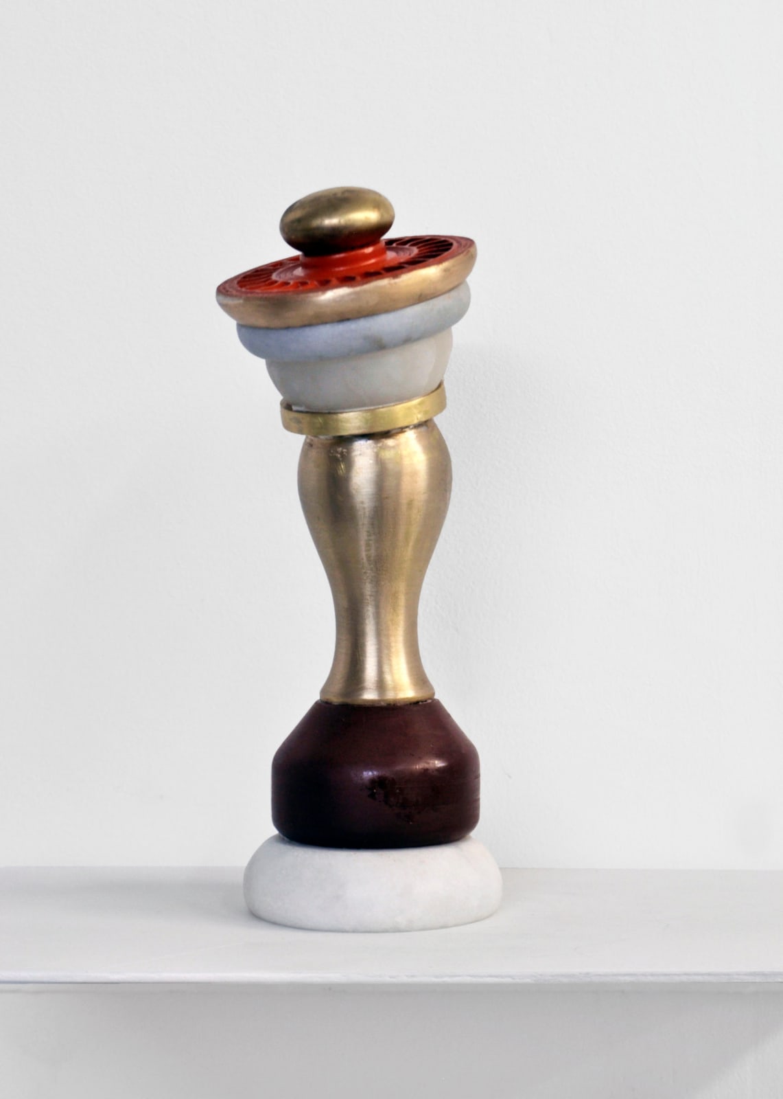 Contemporary minimalist sculpture made of stone and metal that resembles an ambiguous artifact