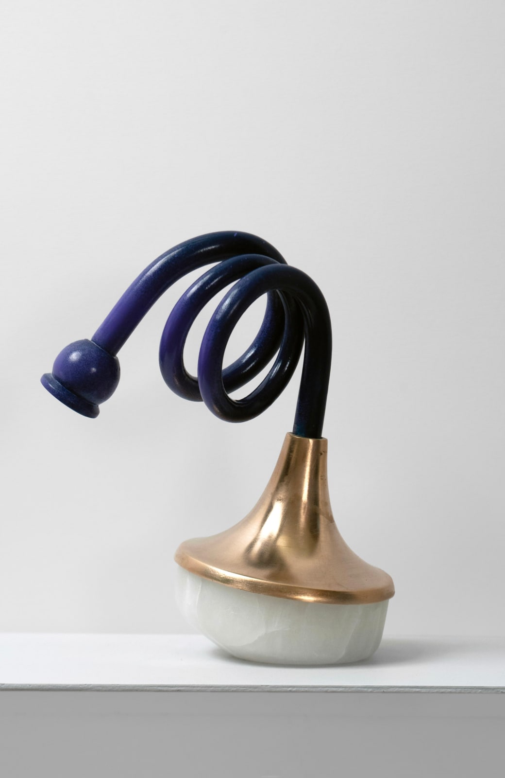 Contemporary minimalist sculpture made of stone and metal that resembles an ambiguous artifact