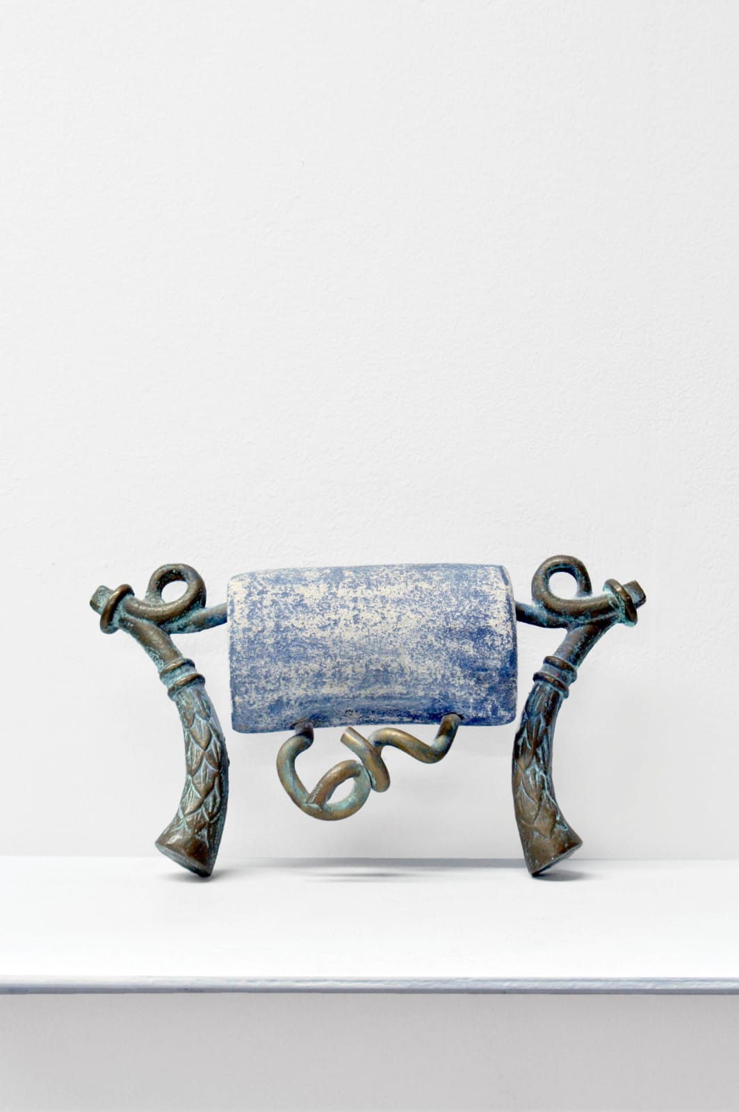 Contemporary minimalist sculpture made of stone and metal that resembles an ambiguous artifact