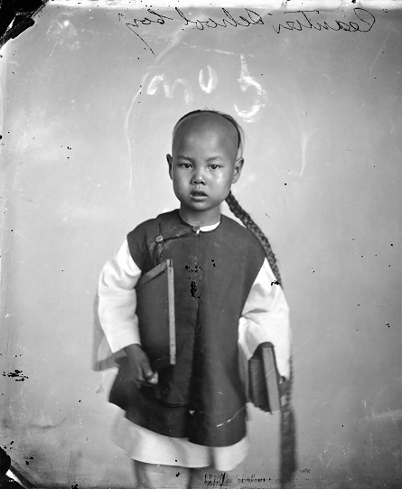 Black and white vintage photograph of a young boy in Guangzhou, China