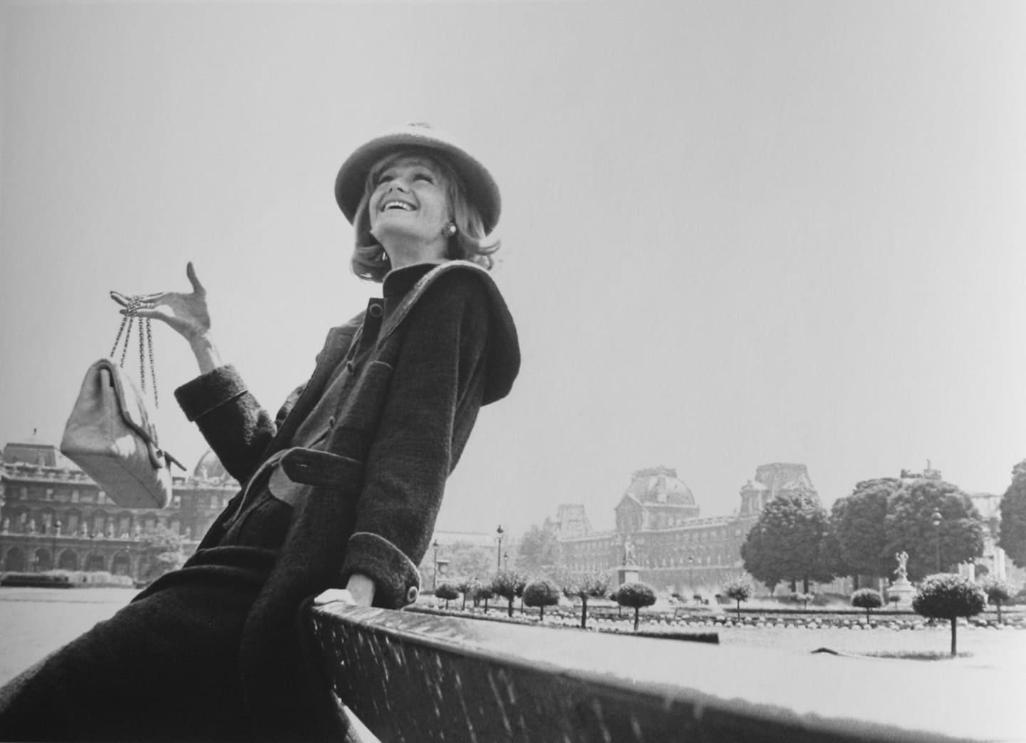 Black and white photograph of model Betty Catroux presenting Chanel fashion in the streets of Paris