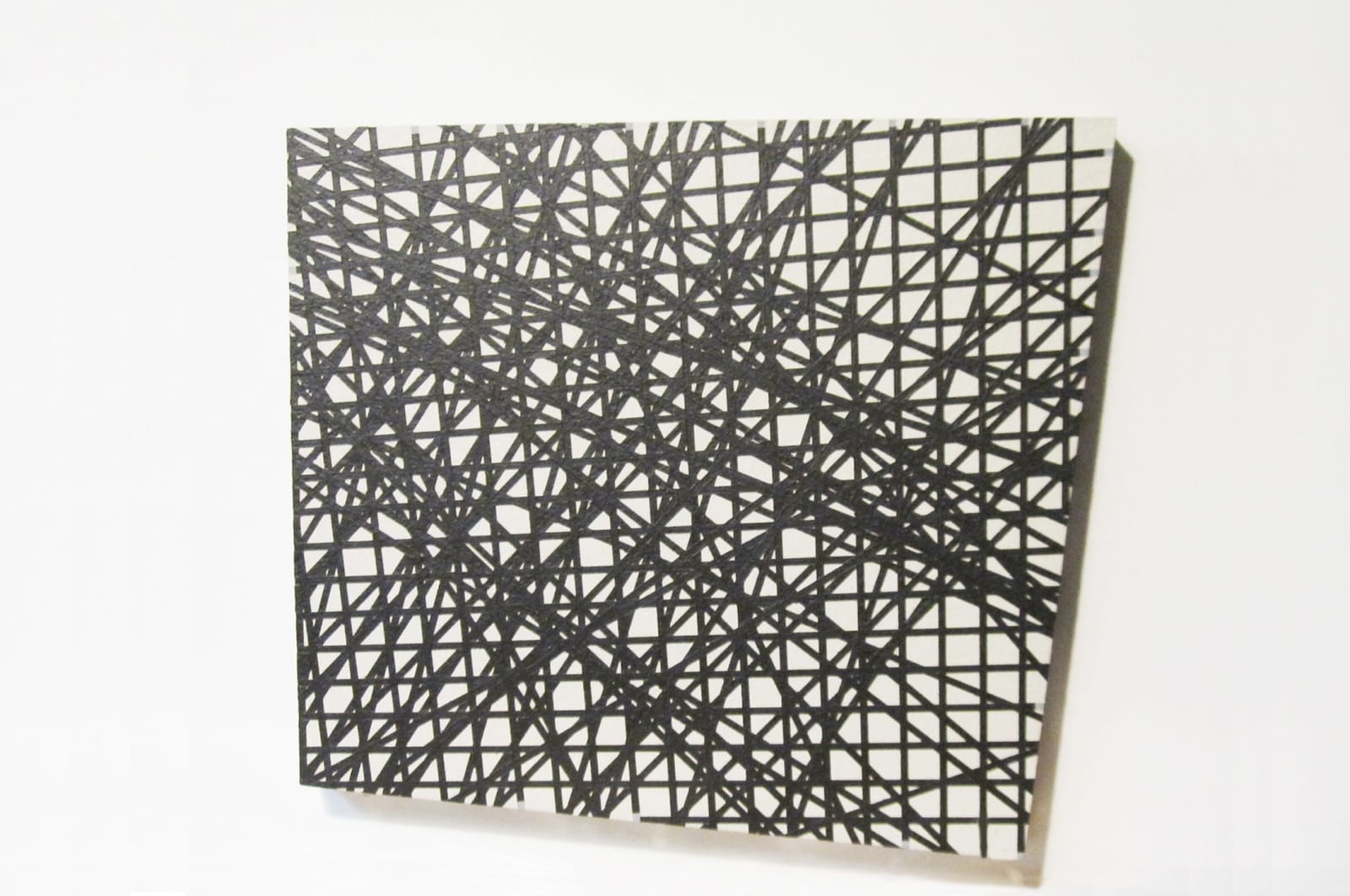 Four-sided acrylic painting on a masonite board with overlaid black grid lines and erratic straight lines
