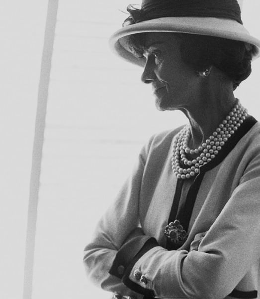Black and white photograph of Designer Coco Chanel in profile in her private apartment at the House of Chanel