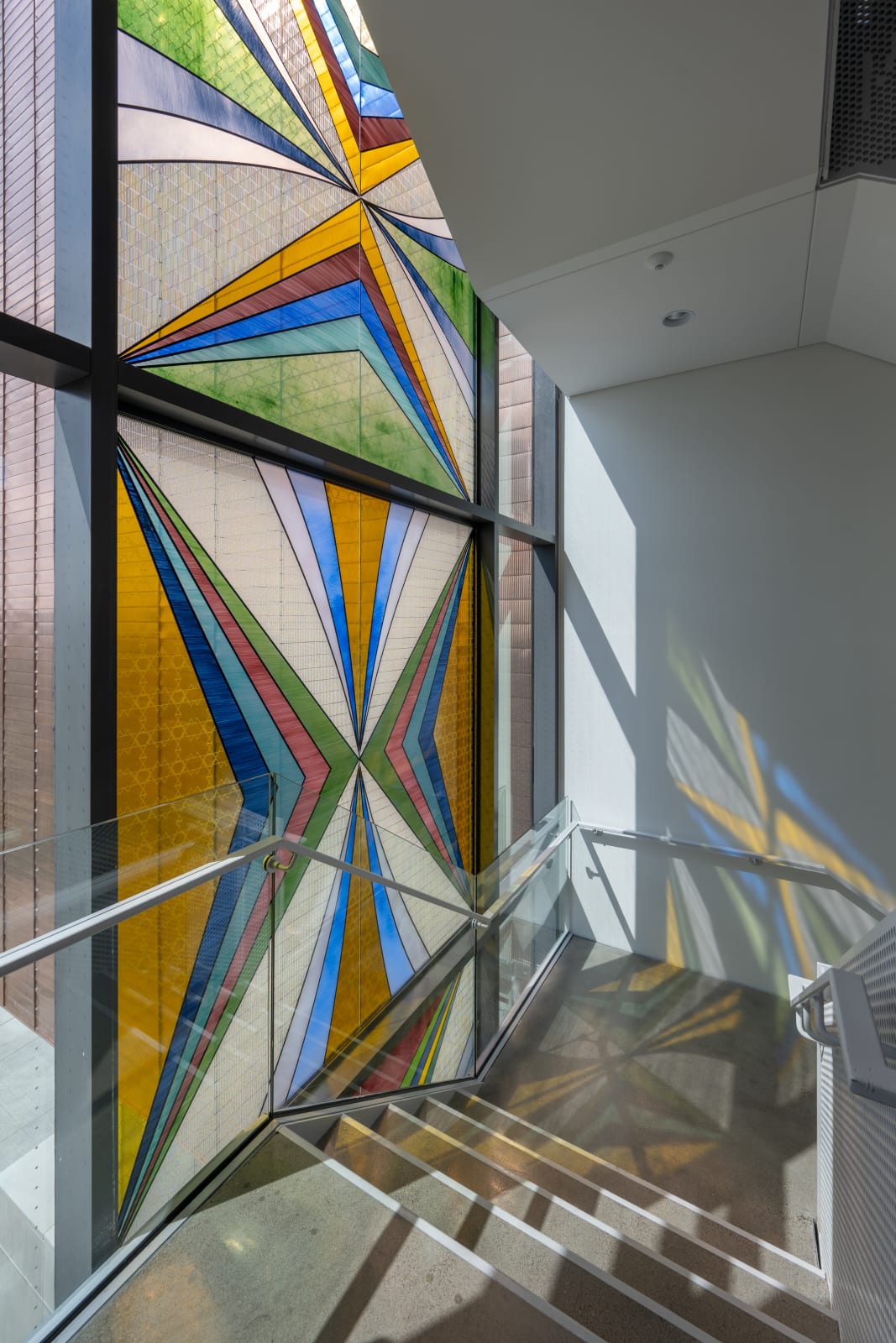 Through the Pursuit of Understanding our Connectivity, We Care for Our World, 2025 Hand-painted and digitally-printed transparent ceramic enamel paint on float glass Art glass by Franz Mayer of Munich Approx. 778 x 90 in (1976.12 x 228.6 cm) Fraser Hall, University of Minnesota, Minneapolis Photo: Rik Sferra