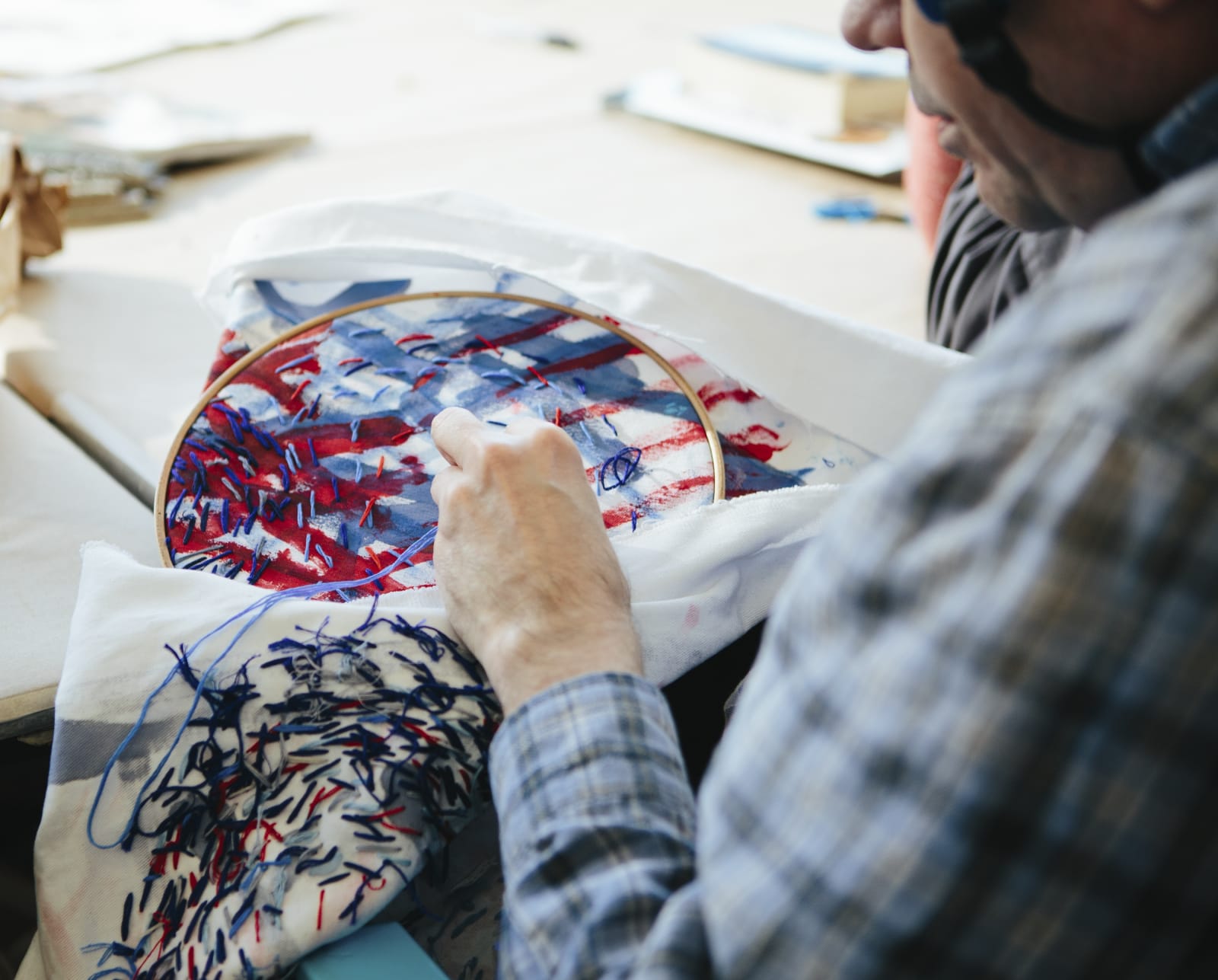 Dan Miller embroidering a textile painting (Photo by Diana Rothery)