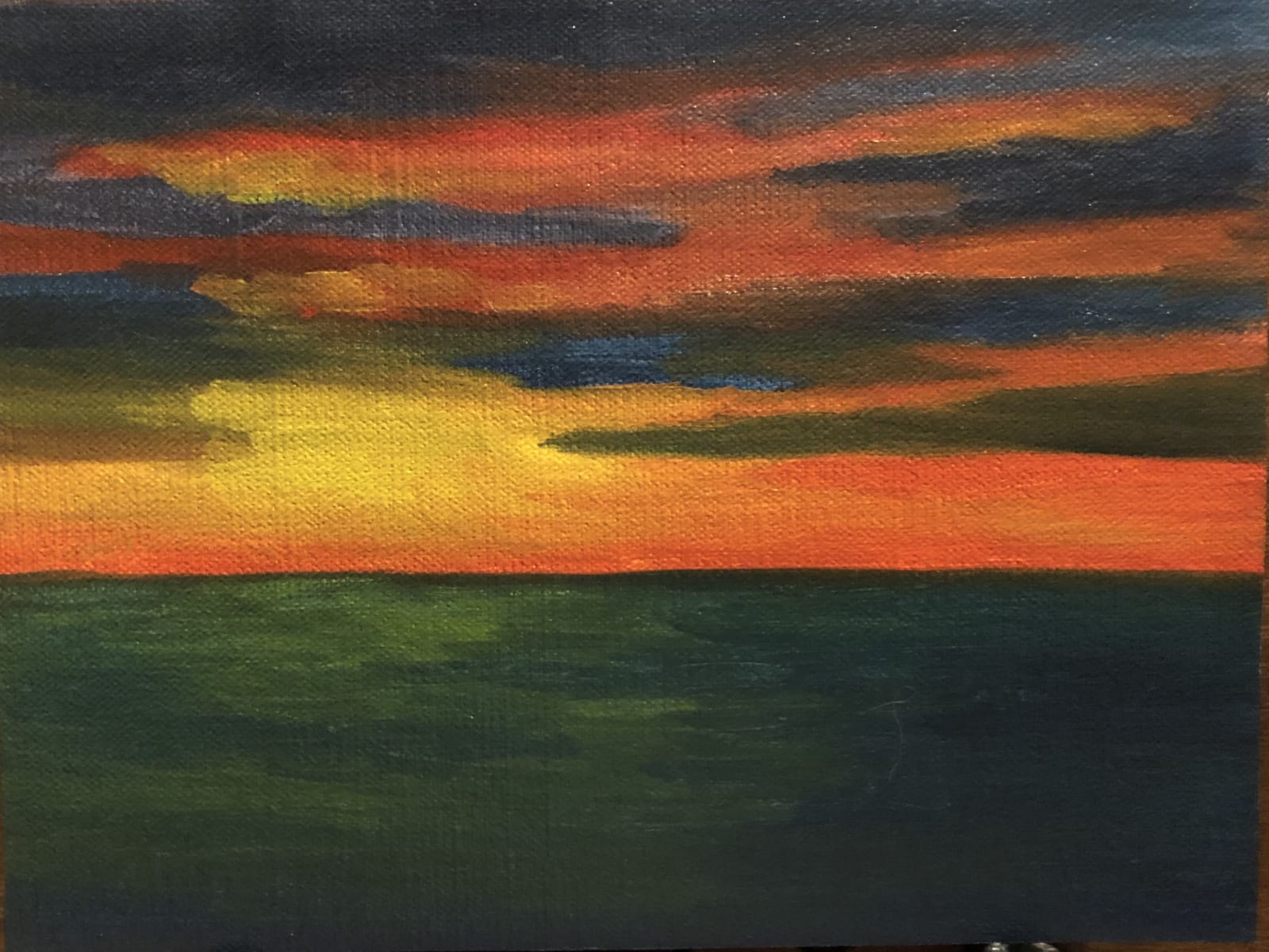 Painting of a sunset on water.