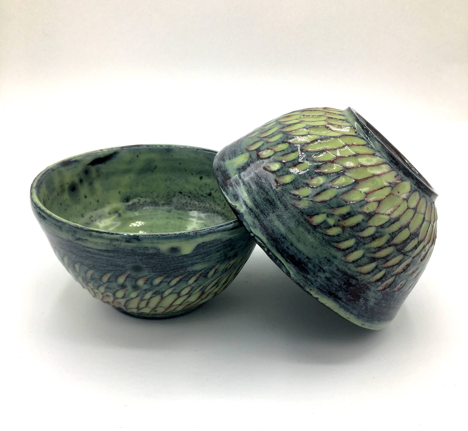 A pair of green bowls