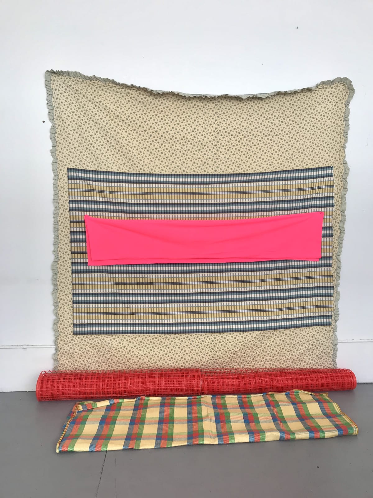 red yellow tan assemblage recycled textiles fence installation