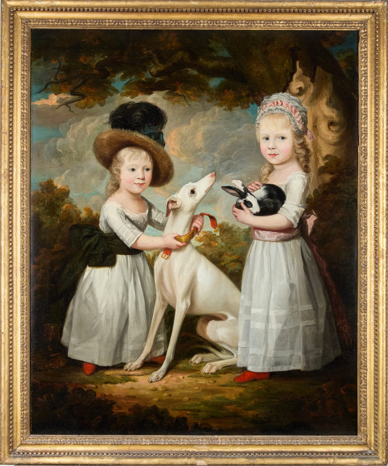 George James (London Fl. 1755-1795 Boulogne), Portrait of two young girls with a whippet and a rabbit in a wooded landscape, circa 1765