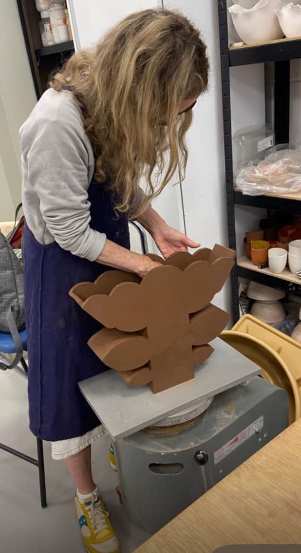 Deborah Tiso slab building a flower vessel in her studio. © The Artist
