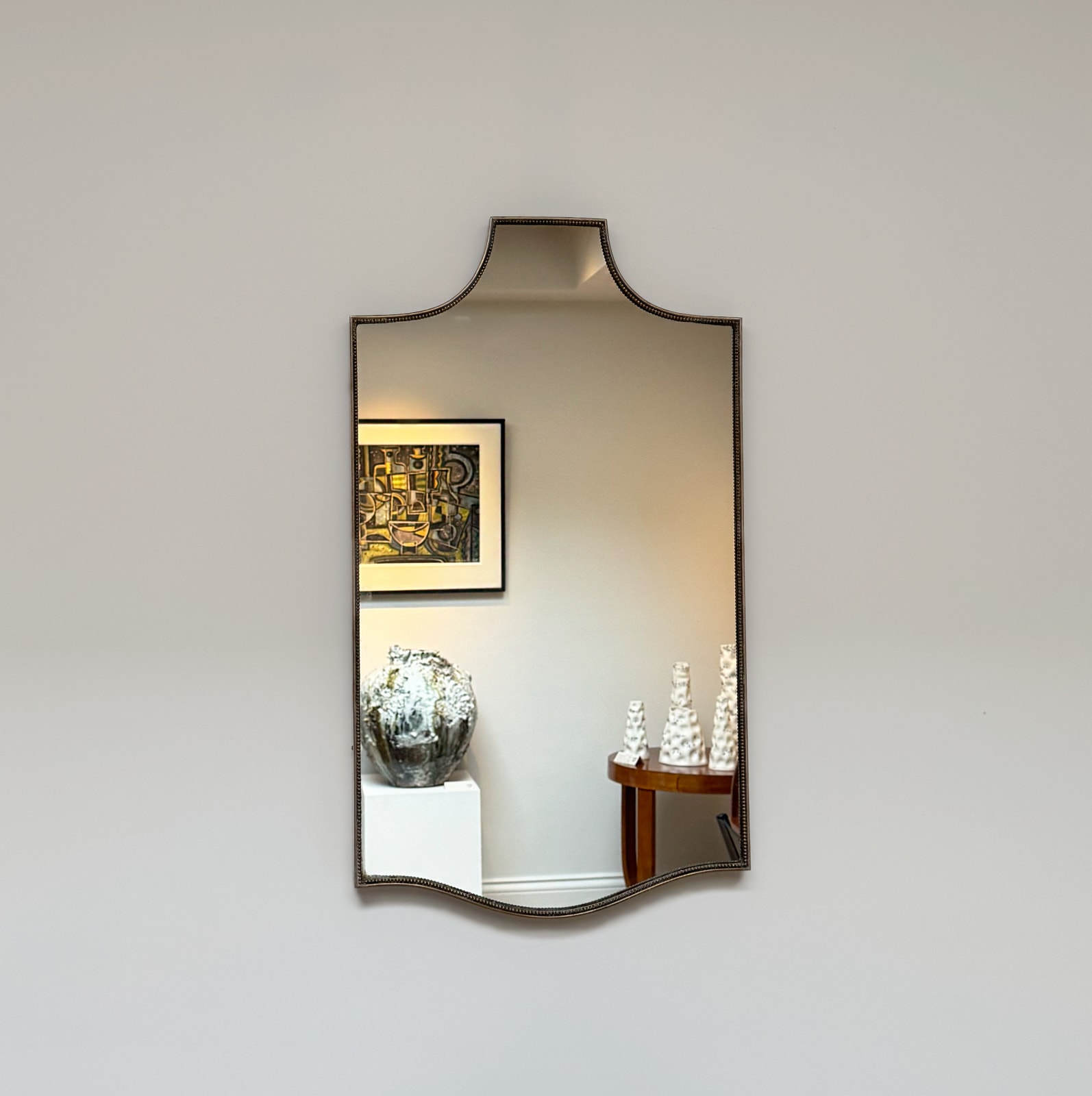 Italian, A Beaded Shield Mirror, circa 1960s