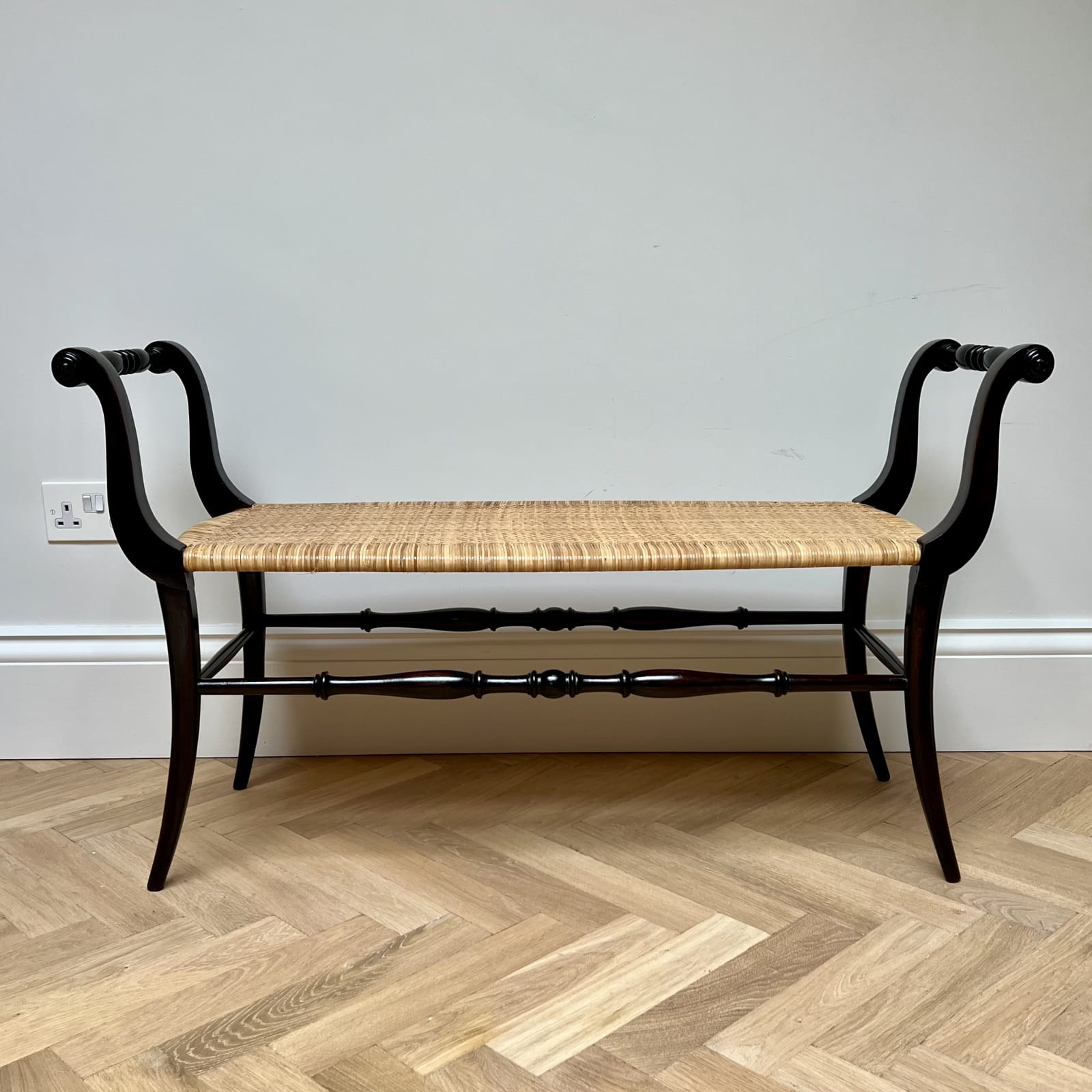 Italian, An Ebonized Wood and Rattan Bench, Circa 1950s