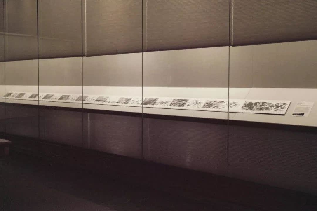 The album is unfolded and displayed in the museum's showcase