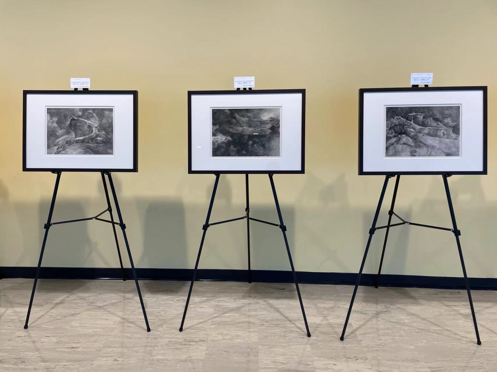 three paintings by Tai Xiangzhou, exhibiting on tripod stands