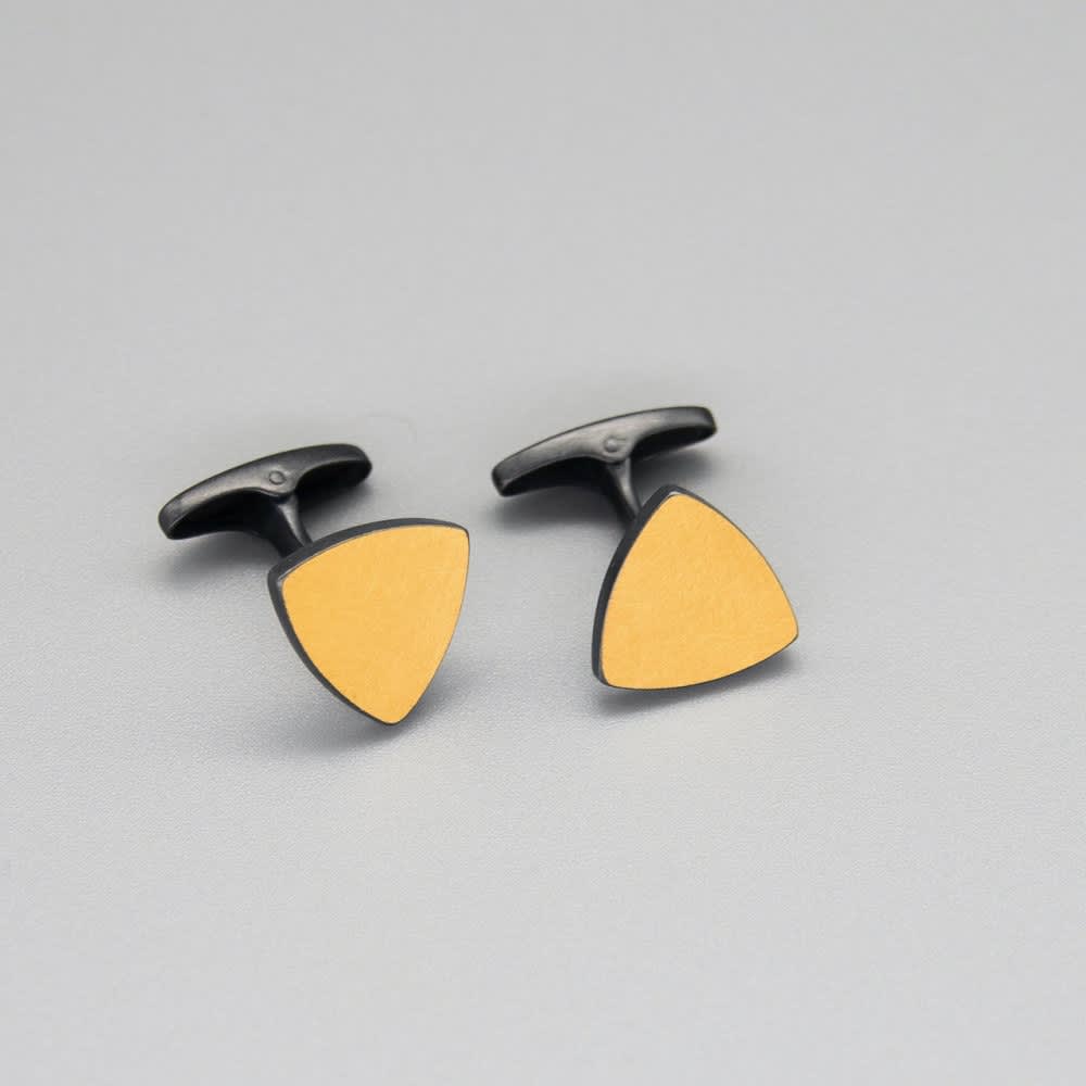 Sheng Zhang 'One on Another' Triangle Keum-boo Cufflinks, 2022 Oxidised sterling silver, 24K gold foil. Face of cufflink: 13 mm x 13 mm x 13 mm 17 mm whale tail fastening