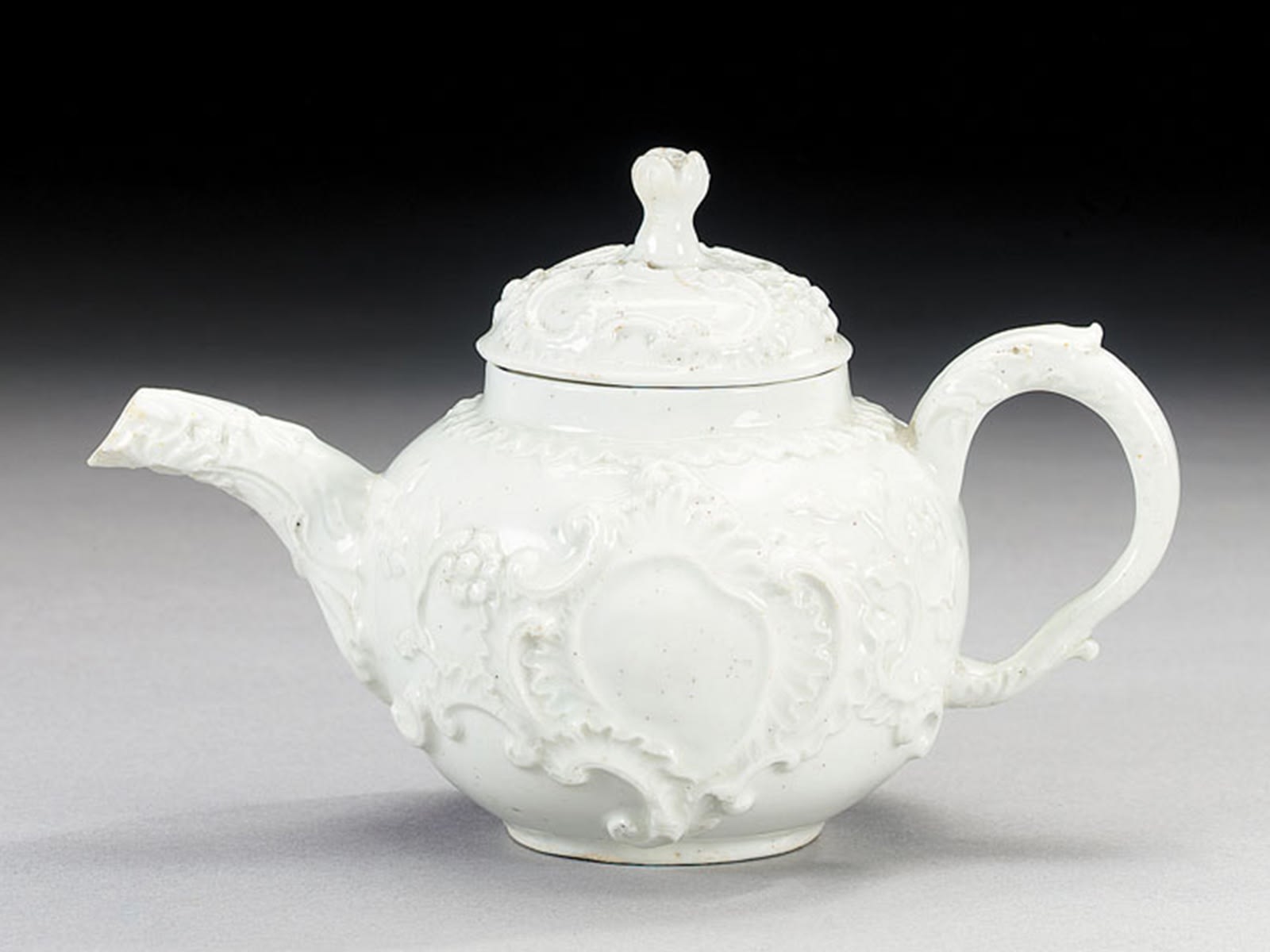 Bow white rococo Teapot and Cover moulded in the ‘silver taste’, Circa 1755