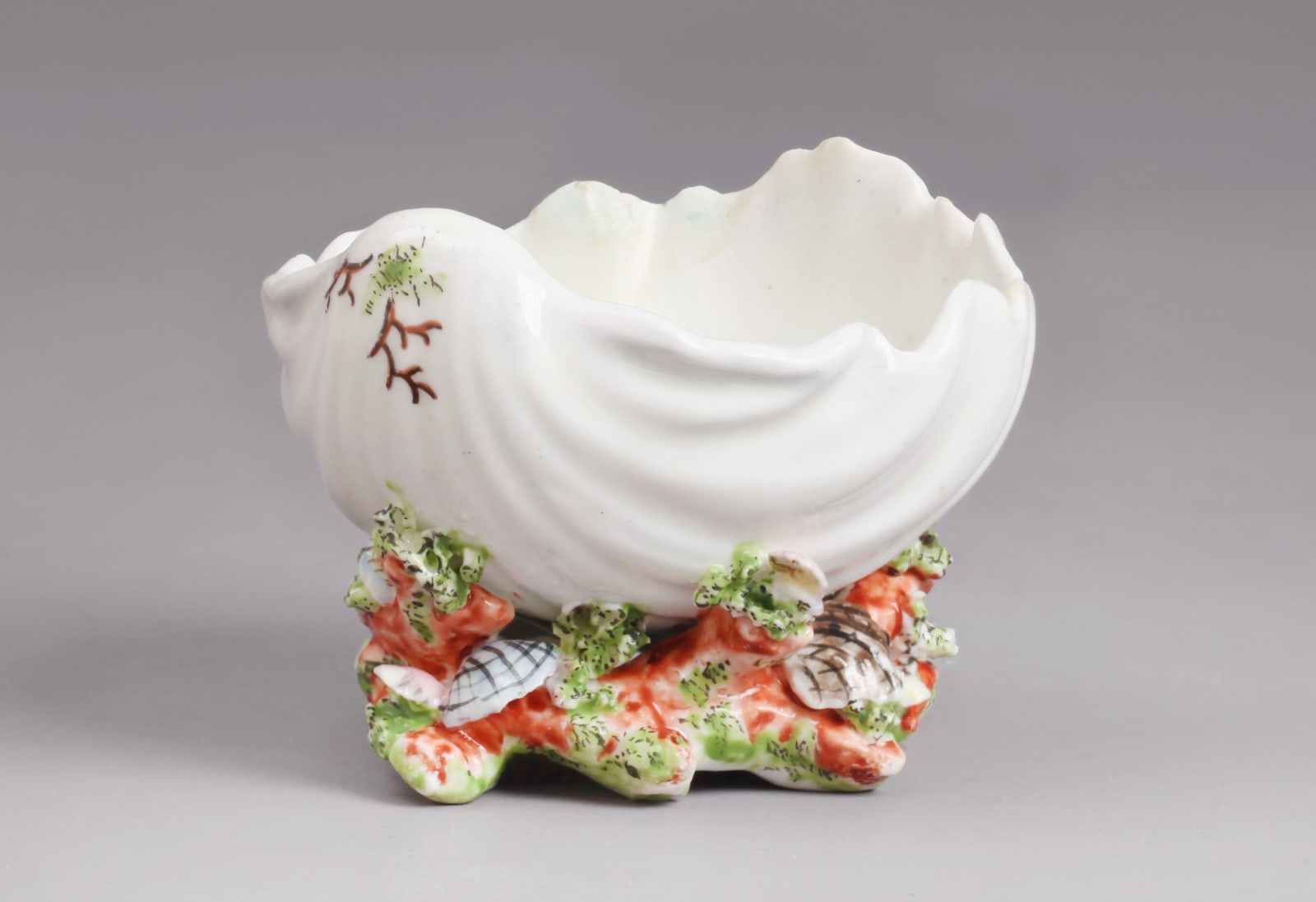 An extremely rare Chelsea Porcelain Coloured Shell and Coral Encrusted Scallop Shell Salt, Circa 1745-49