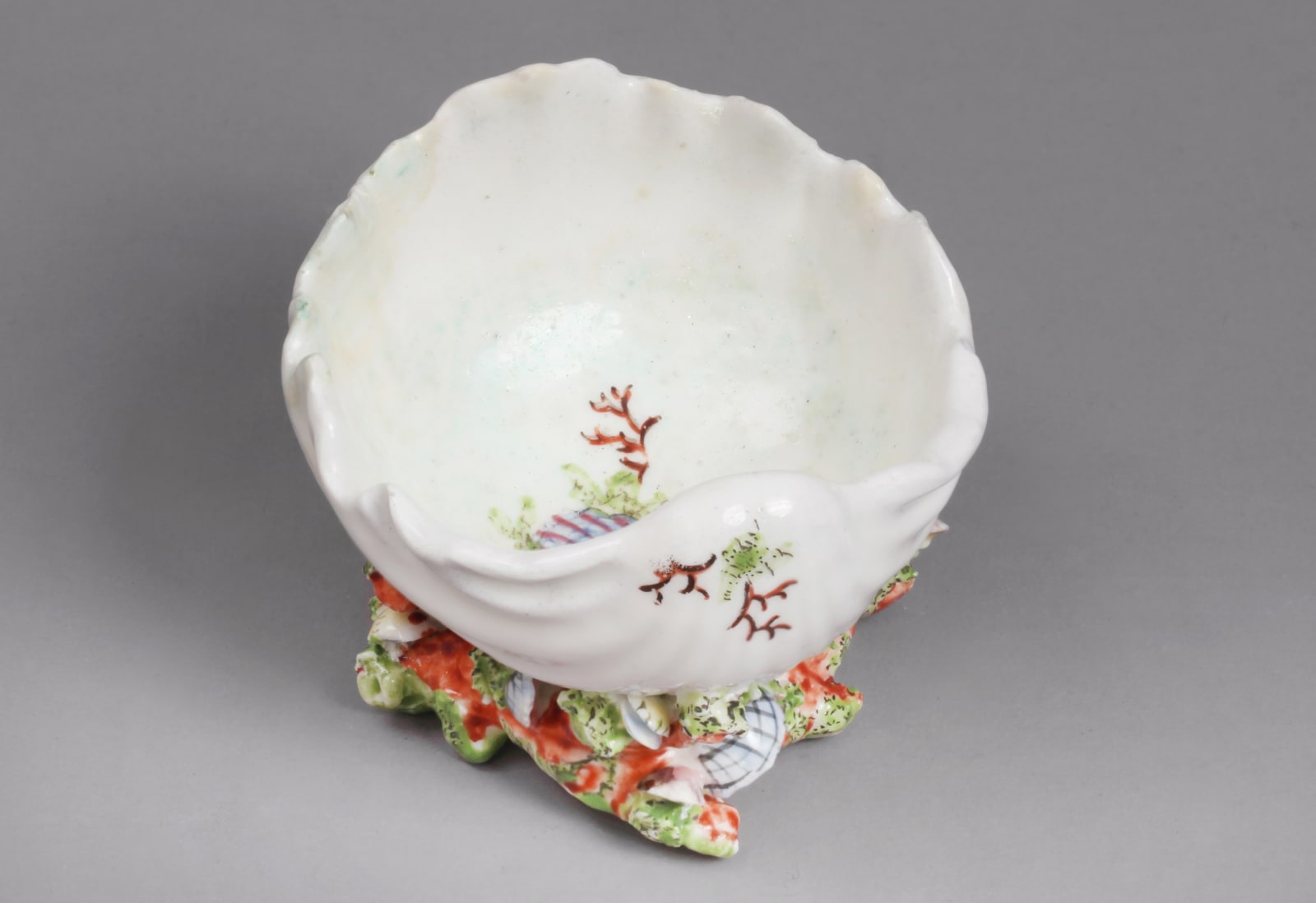 An extremely rare Chelsea Porcelain Coloured Shell and Coral Encrusted Scallop Shell Salt, Circa 1745-49
