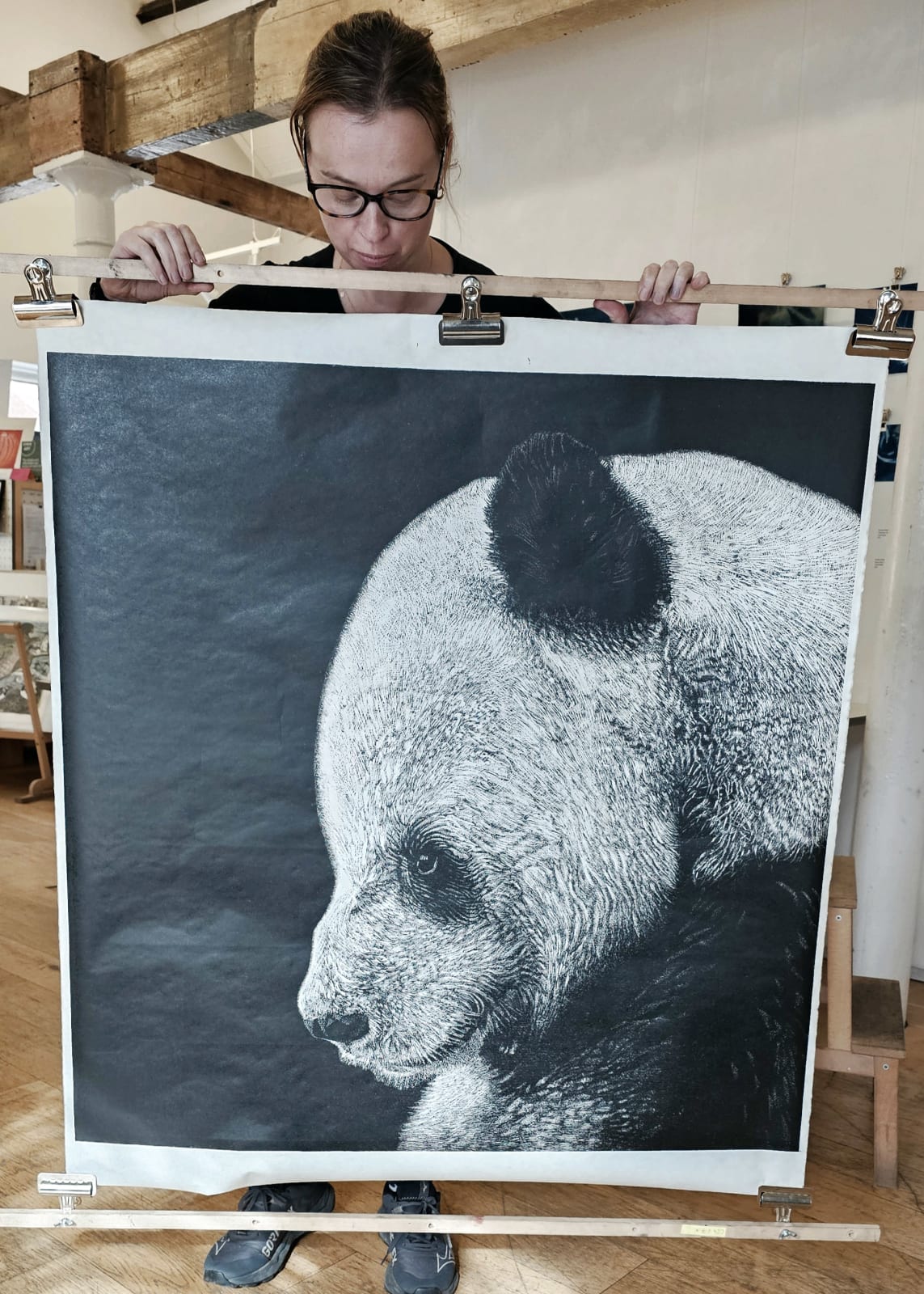 Dramatic elephant linocut print on a black background by Nicola Wallis