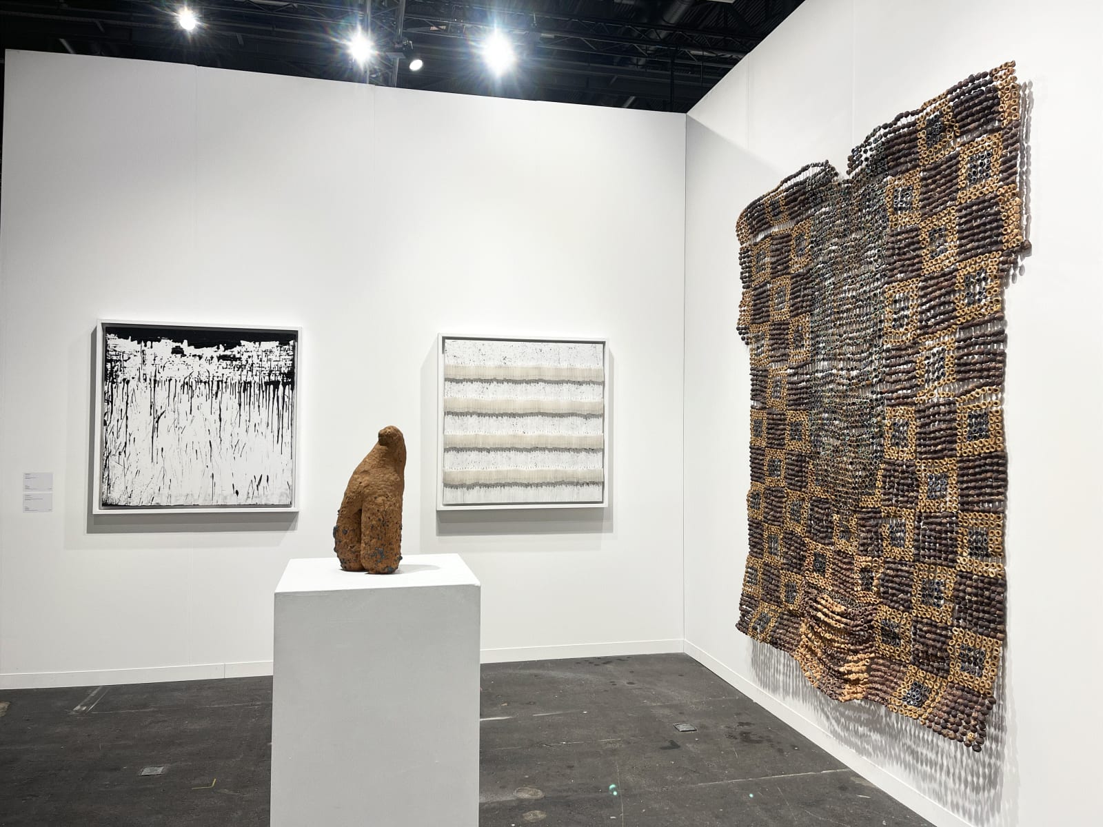 View of AFIKARIS Gallery's booth at Art Genève featuring works by Mouhcine Rahaoui, Ozioma Onuzulike and Salifou Lindou