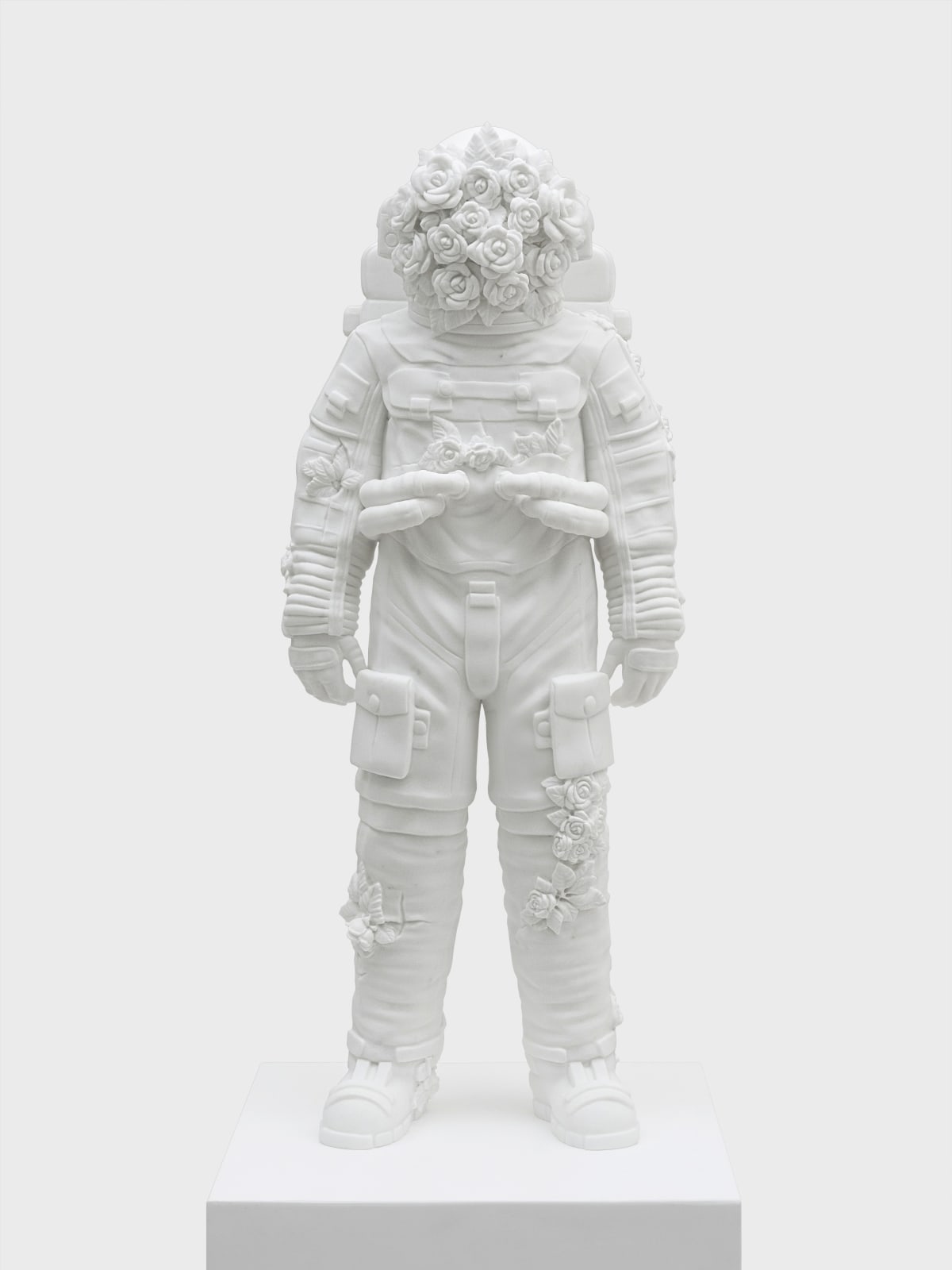 Marble sculpture featuring a spaceman his suit fill of flowers, part of the 'Spaceman' series by artist Filippo Tincolini view from the front
