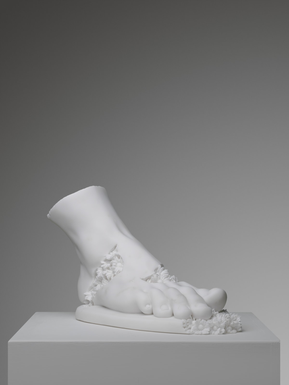 Marble sculpture featuring a foot with flowers, part of the 'Flowered Soul' series by artist Filippo Tincolini view from the right front
