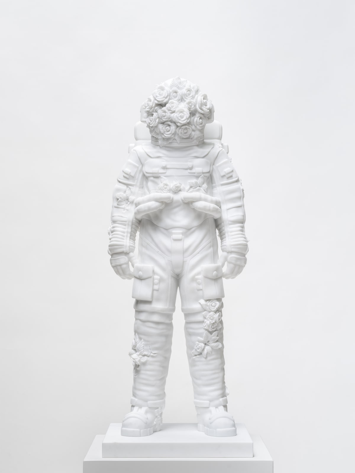 Marble sculpture featuring a spaceman his suit fill of flowers, part of the 'Spaceman' series by artist Filippo Tincolini view from the front