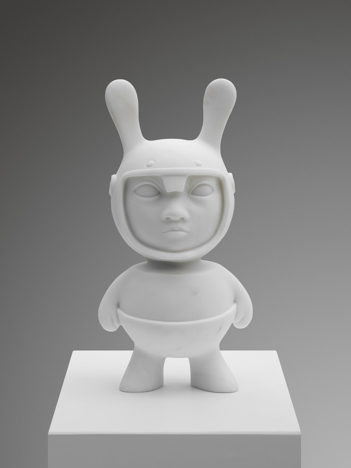 Marble sculpture featuring an alien, part of the 'Toys' series by artist Filippo Tincolini view from the front
