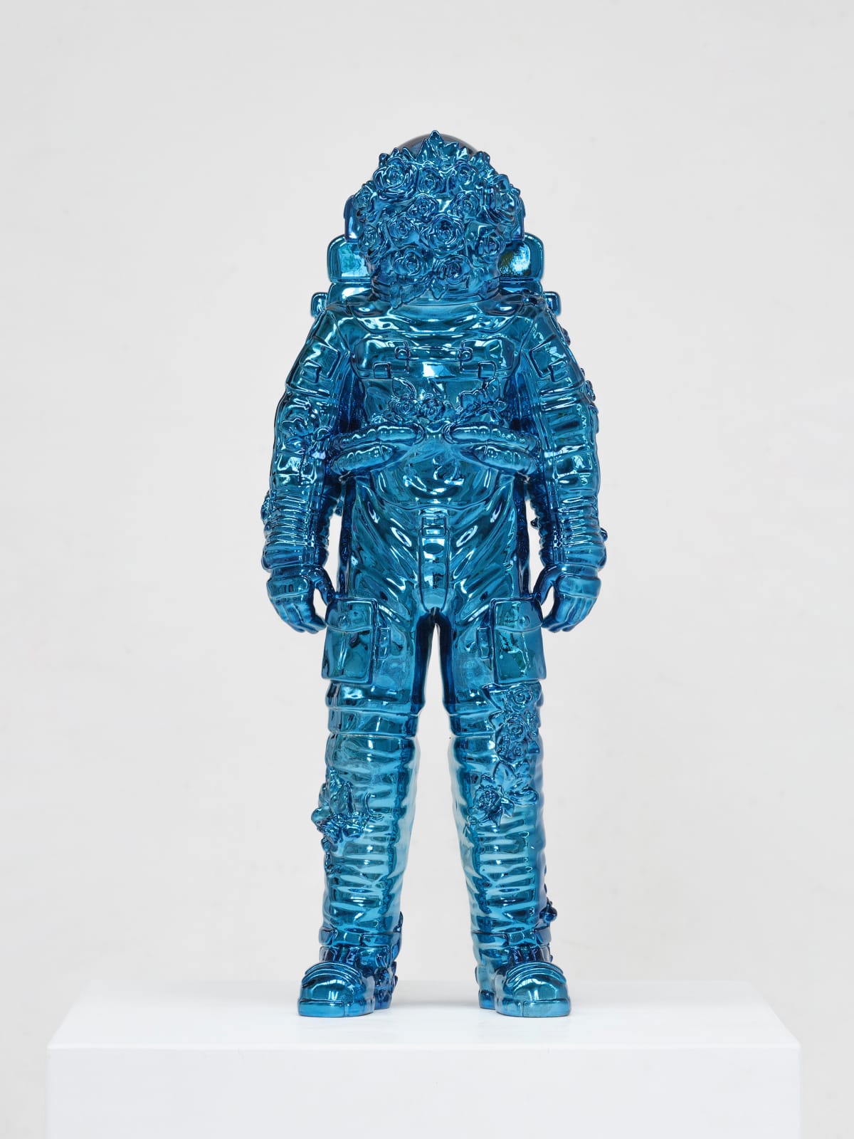 Marble sculpture featuring a spaceman his suit fill of flowers, part of the 'Spaceman Shiny Blue' series by artist Filippo Tincolini view from the front