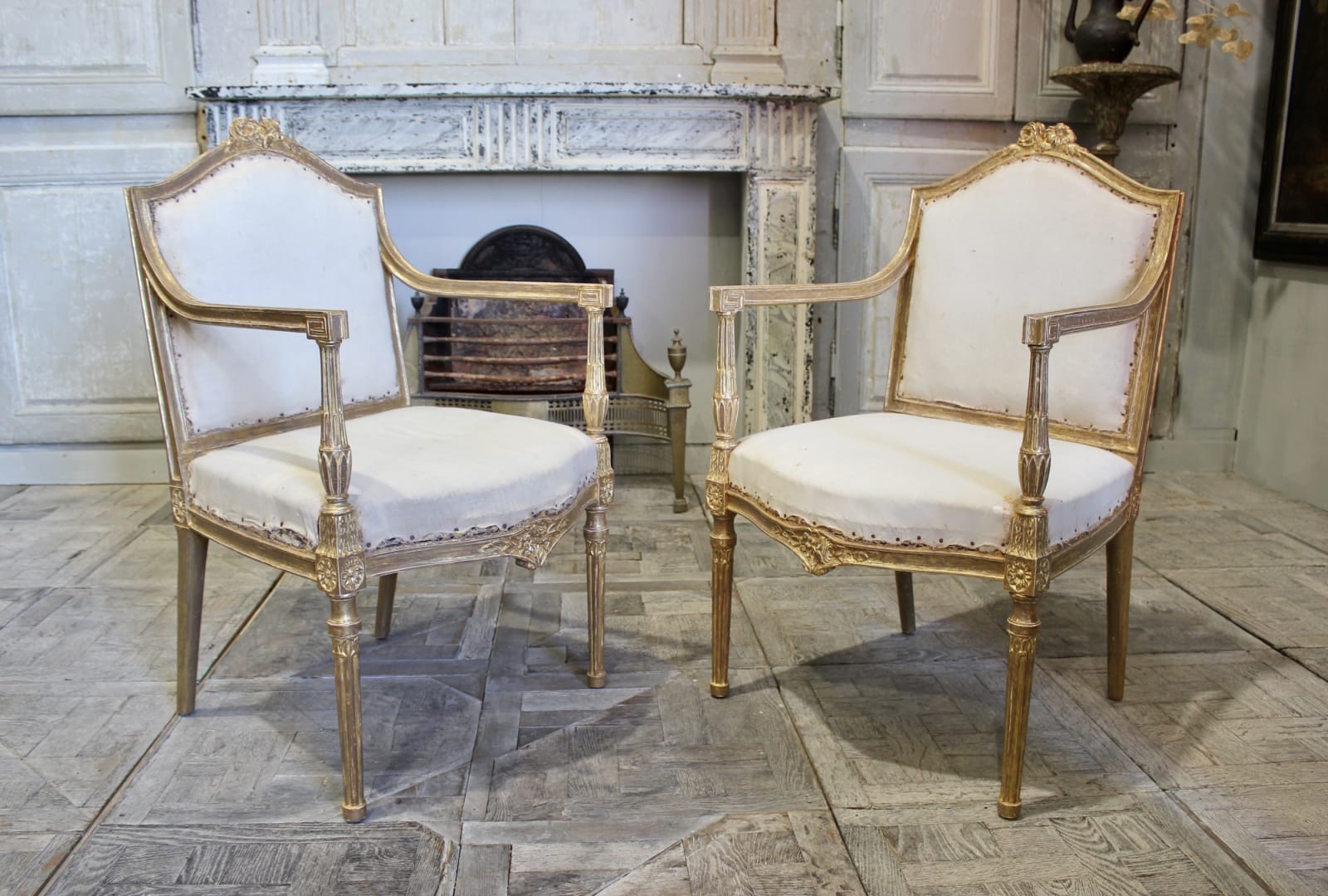 pair of English carved giltwood armchairs in the manner of Thomas Chippendale