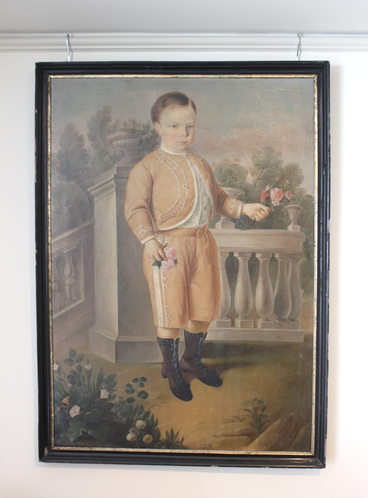 Early 19th century painting of a boy holding flowers