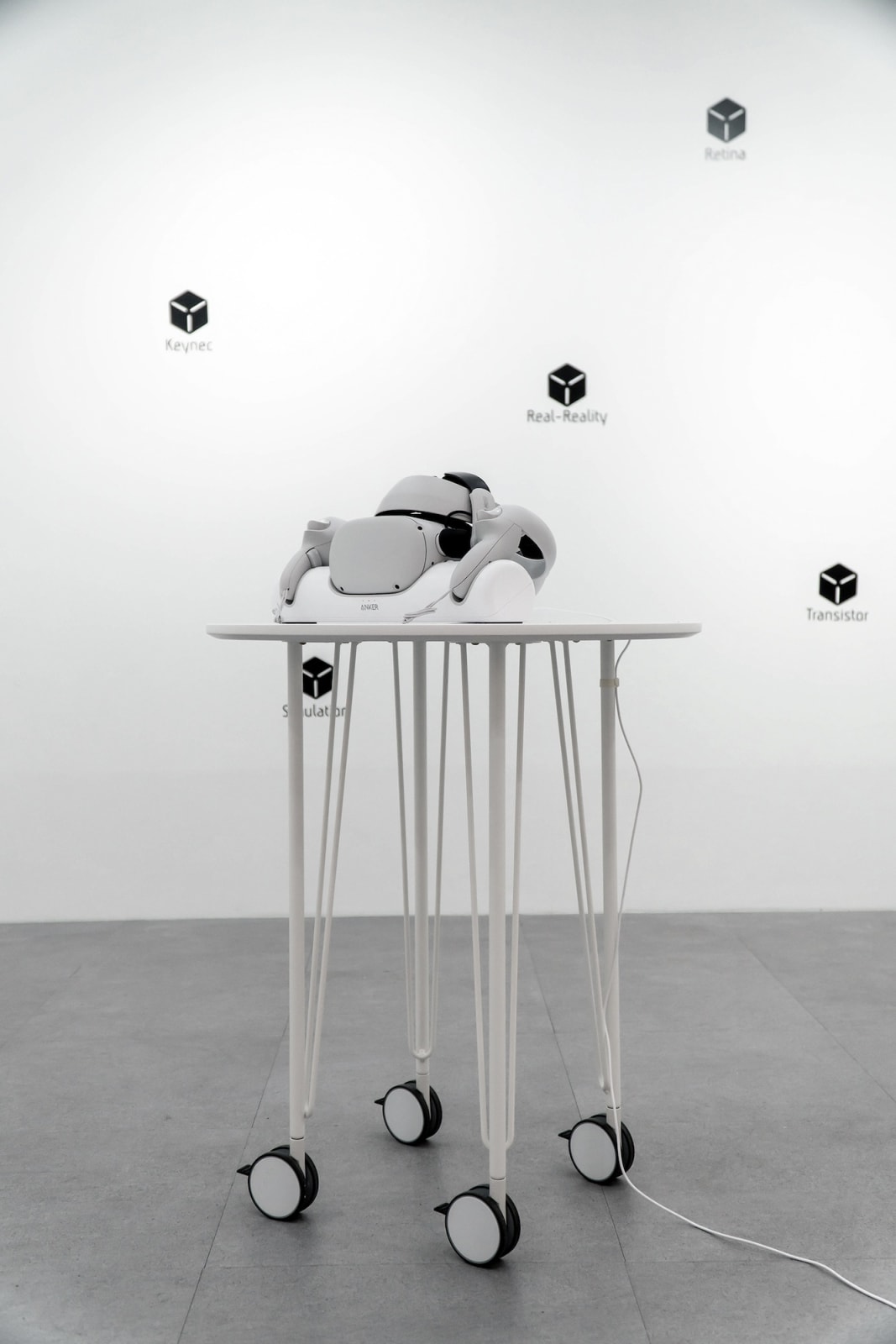 Sword of Damocles, 2022, head-mounted display, charger dock table, interactable VR simulation, 15min, HMD 19 x 10 x 14 cm, chargerdock 38 x 8.5 x 7 cm, table 60 x 60 x 62 cm, Curtesy of the Artist.