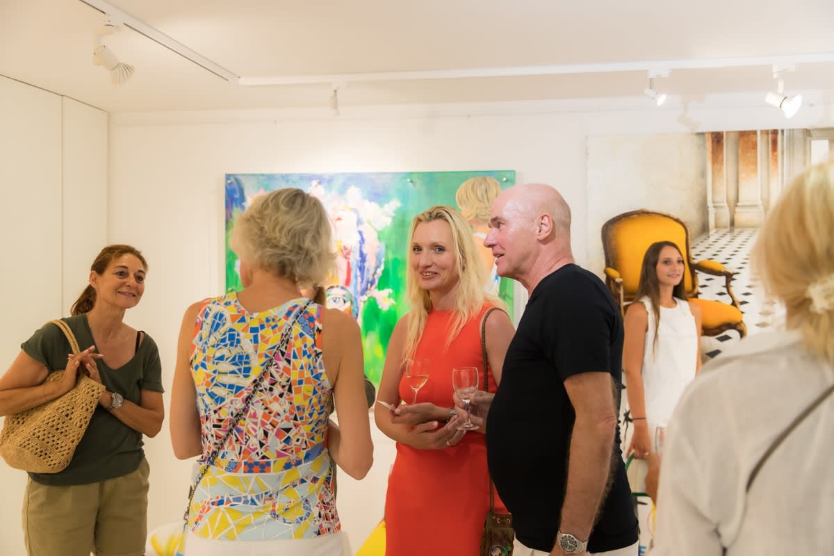 People inside of Carousel Fine Art's gallery space in Saint Tropez.