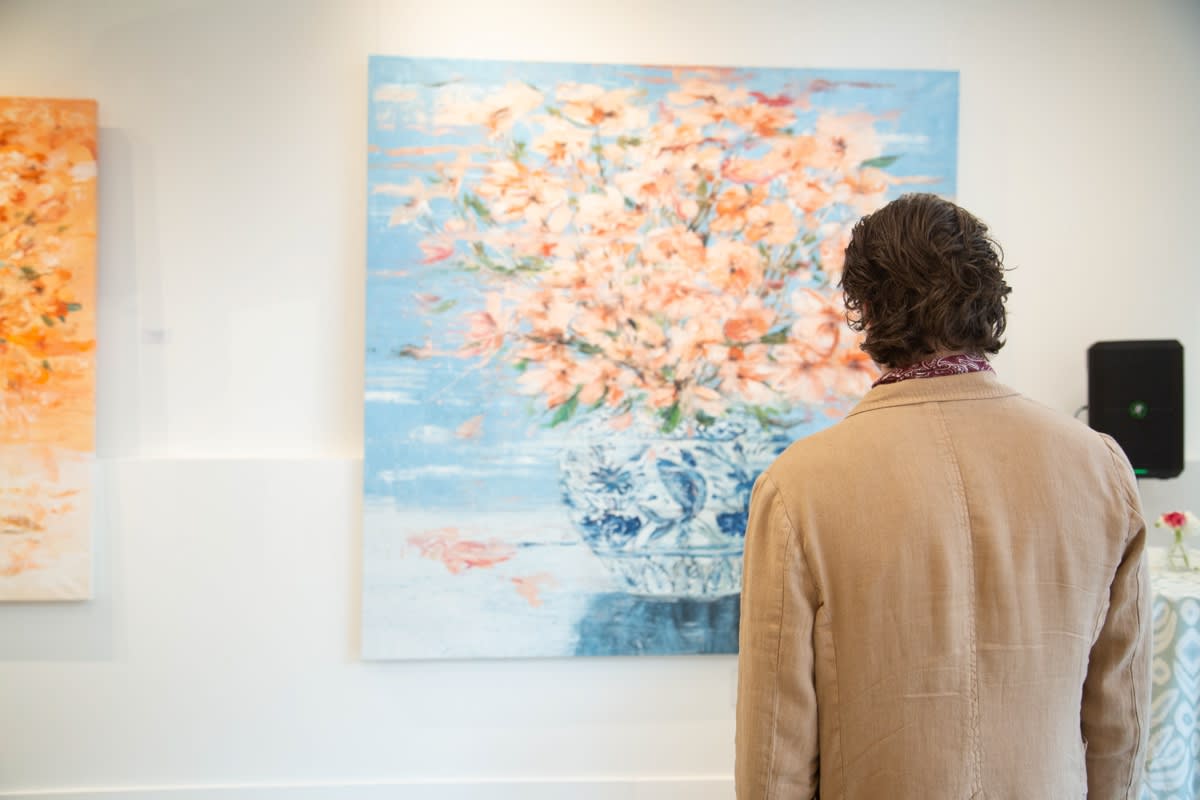 Man staring at painting by Eric Alfaro displayed in Carousel Fine Art's Buckhead Village location during the exhibition "Spring Reverie."
