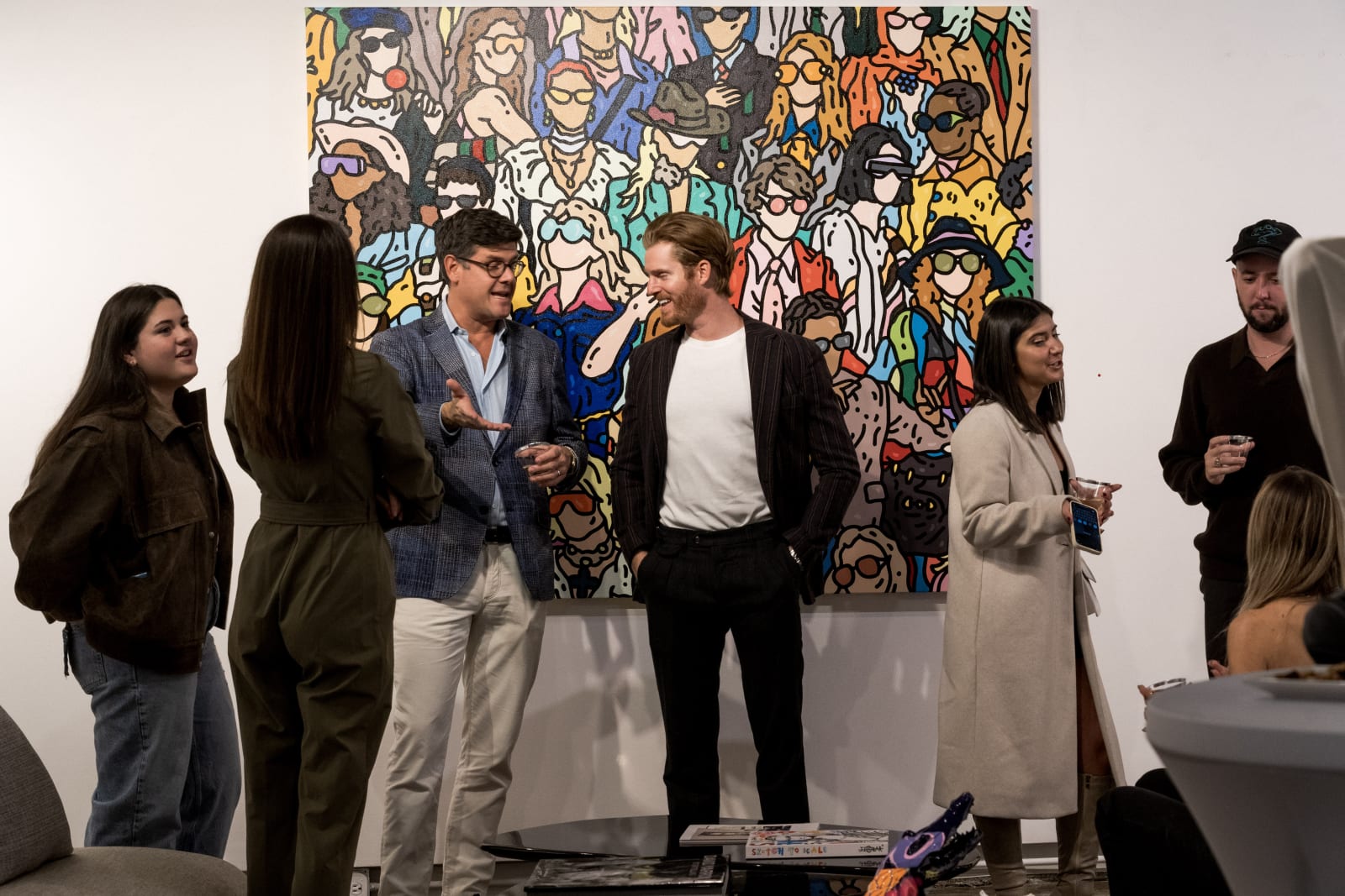 People at a Chicago art event, a solo exhibition for artist Chance Cooper titled "Action!", hosted by Chicago art gallery Carousel Fine Art.