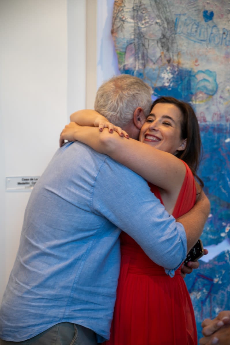 People hugging at Carousel Fine Art's Miami gallery space for the exhibition, "If These Walls Could Talk."