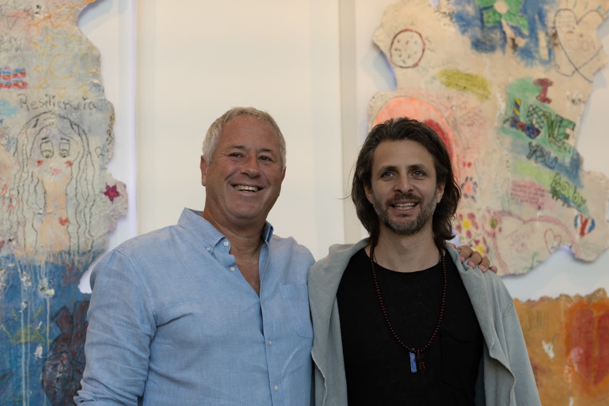 Men posing for photograph at Carousel Fine Art's Miami gallery space for the exhibition, "If These Walls Could Talk."