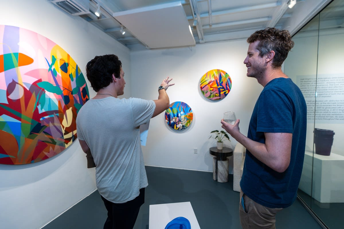 People inside Carousel Fine Art's Miami gallery space during Neill Wright's exhibition "Where the Light Gets In."