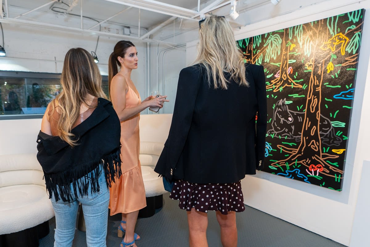 People inside Carousel Fine Art's Miami gallery space during Neill Wright's exhibition "Where the Light Gets In."