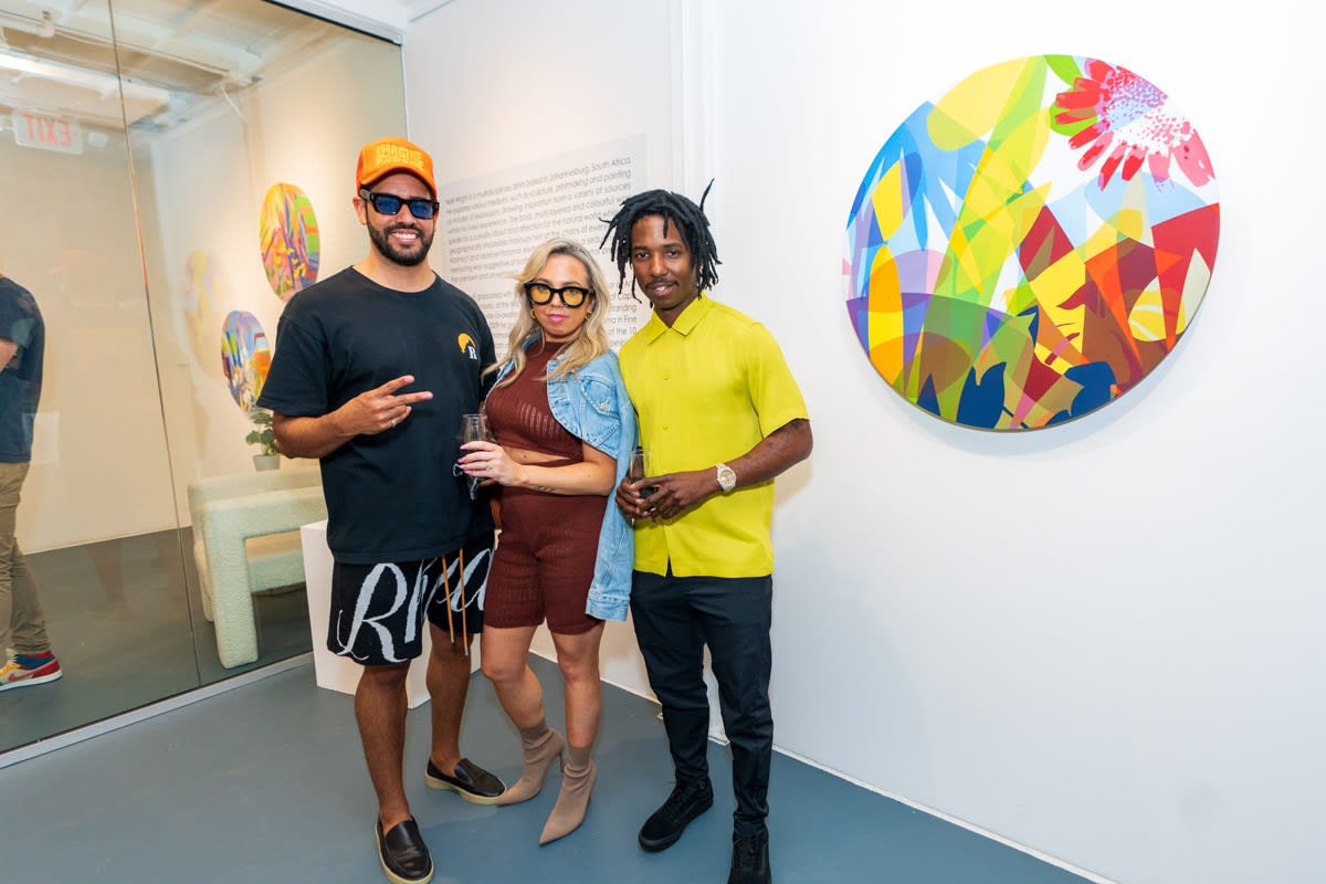 People inside Carousel Fine Art's Miami gallery space during Neill Wright's exhibition "Where the Light Gets In."