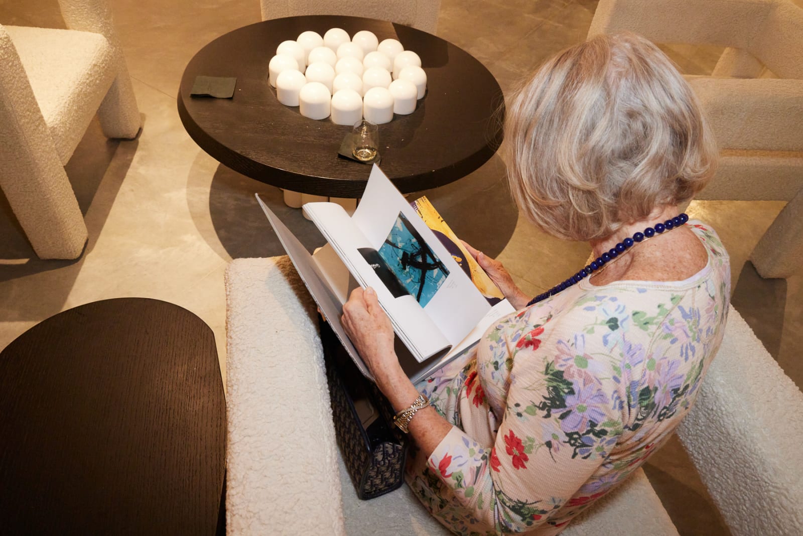 Lounge seating area with guests relaxing while reading about Eric Alfaro at NORA District opening.
