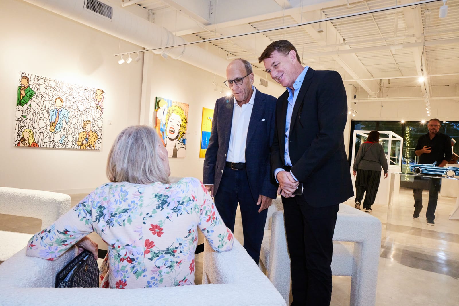 Crowd shot of West Palm Beach collectors enjoying contemporary art and champagne in the NORA District gallery.