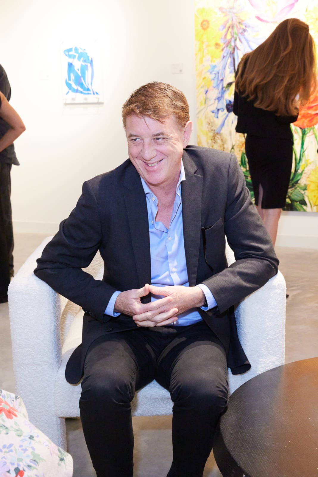 Collector admiring Eric Alfaro koi and lily pad painting at our new NORA West Palm gallery location.