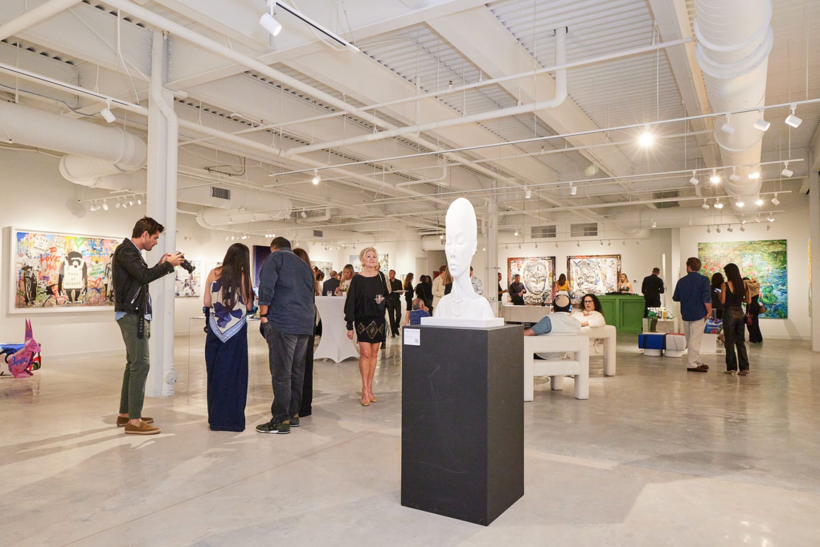 High-energy grand opening moment with packed NORA West Palm gallery and multiple artists’ works on display.