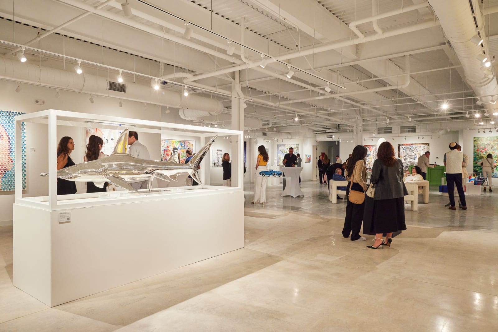 Wide crowd shot of guests filling our NORA District West Palm Beach gallery during the grand opening celebration.