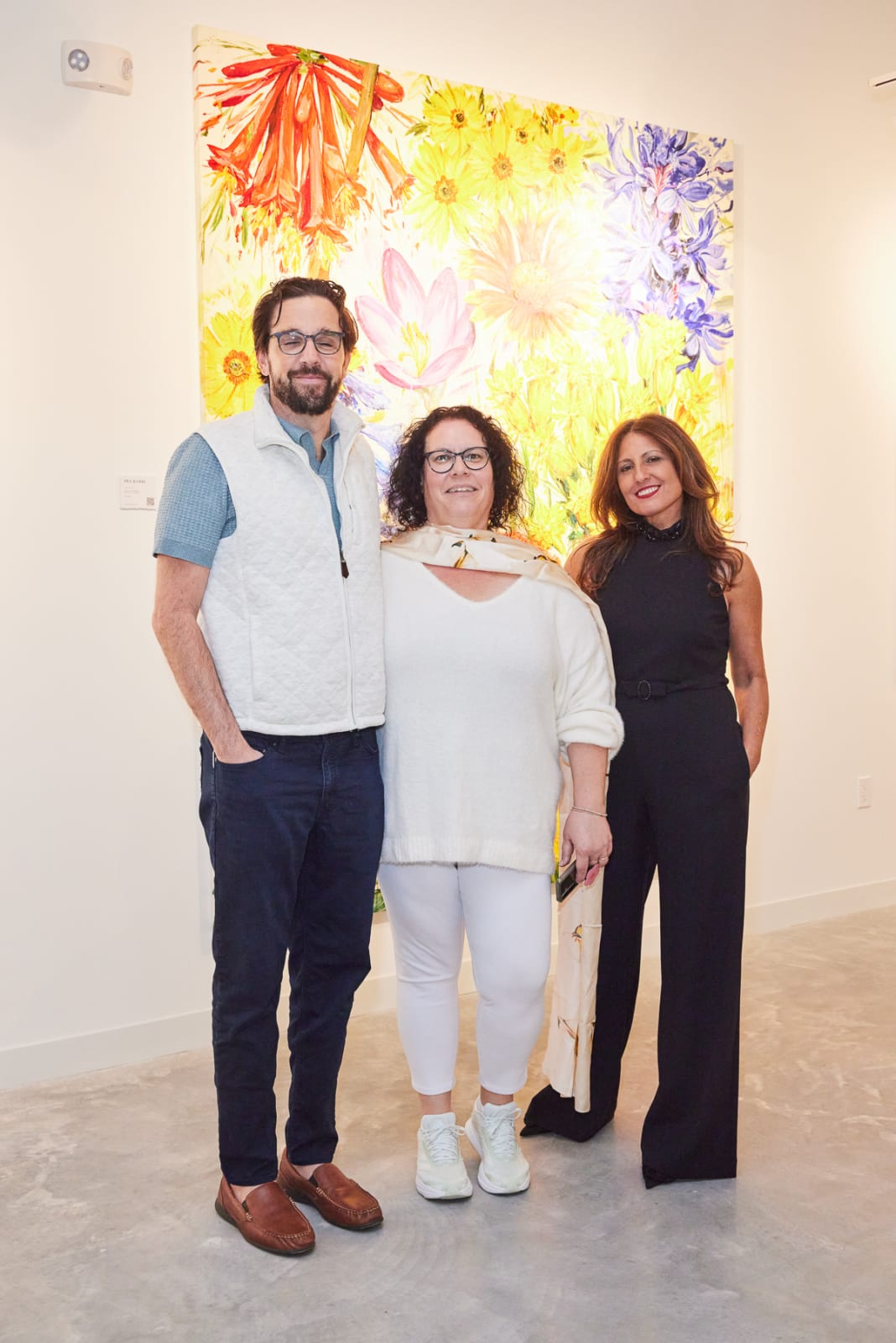 Couple posing with advisor in front of Sylvain Tremblay and Zhuang Hong Yi works at NORA District grand opening in West Palm.