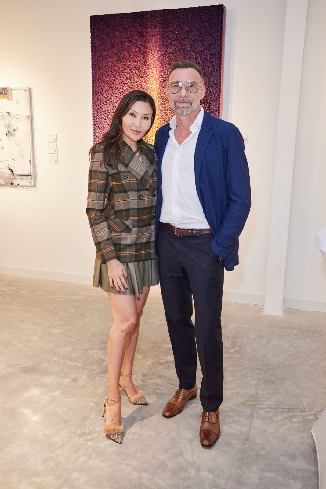 VIP couple posing in from of gorgeous color shifting work by Zhuang Hong Yi.