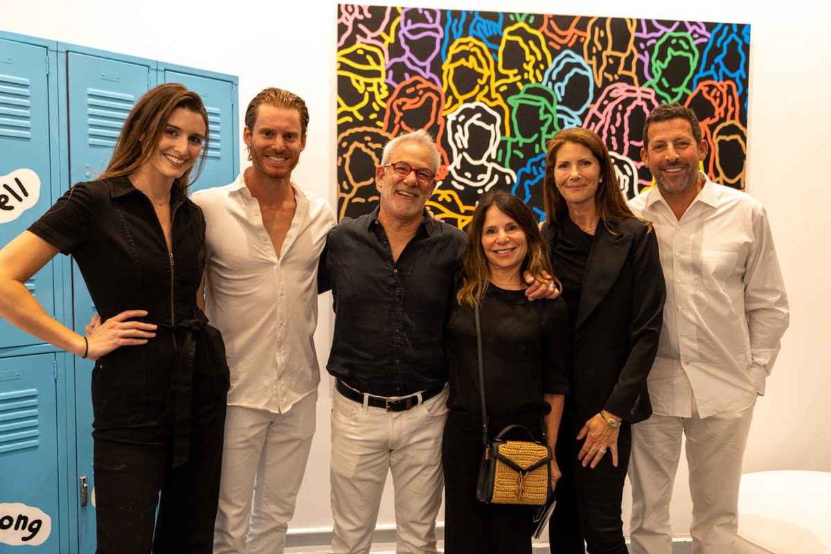 People posing in front of painting at Carousel Fine Art's gallery space in Miami, FL during Chance Cooper's Spotlight Exhibition, "Between Me and You."